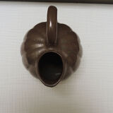 Old pitcher in glazed brown ceramic