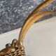Golden metal chandelier decorated with flowers