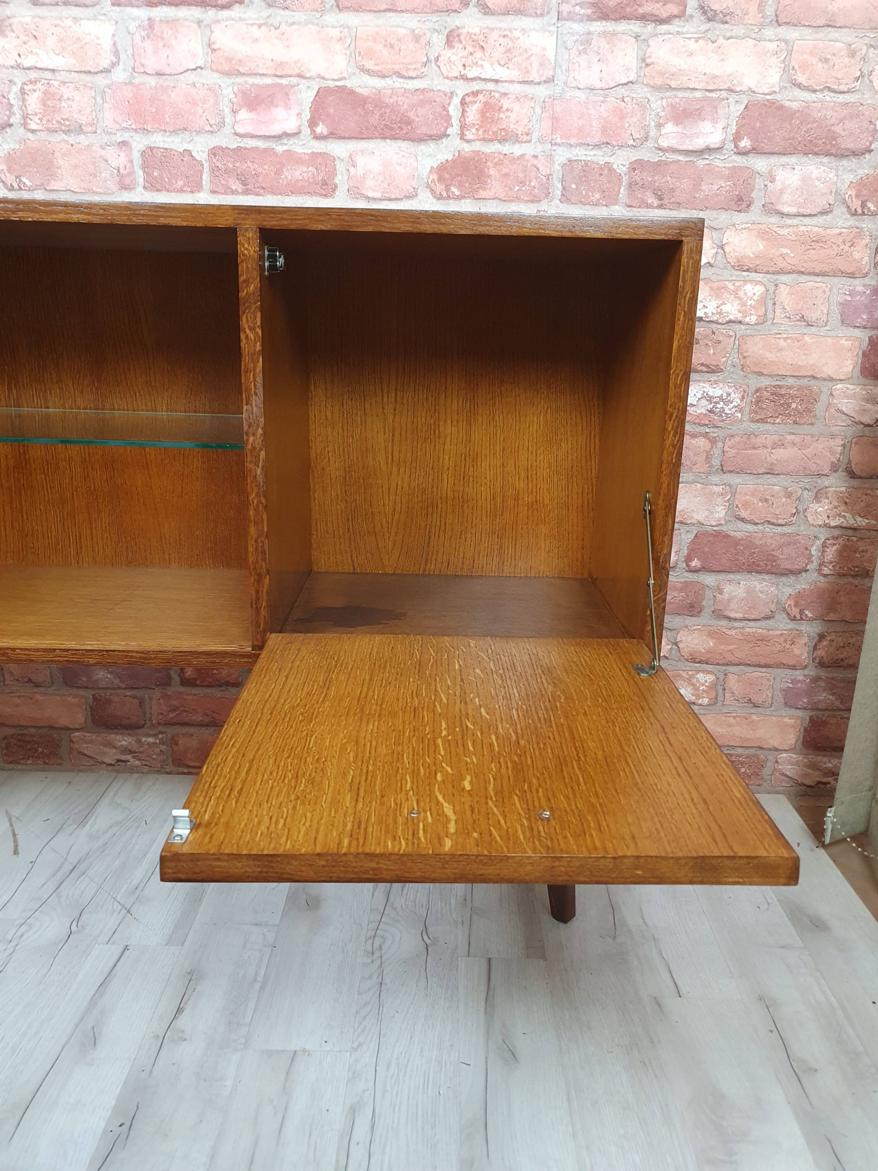 Renovated oak display cabinet with a bar on slanted legs