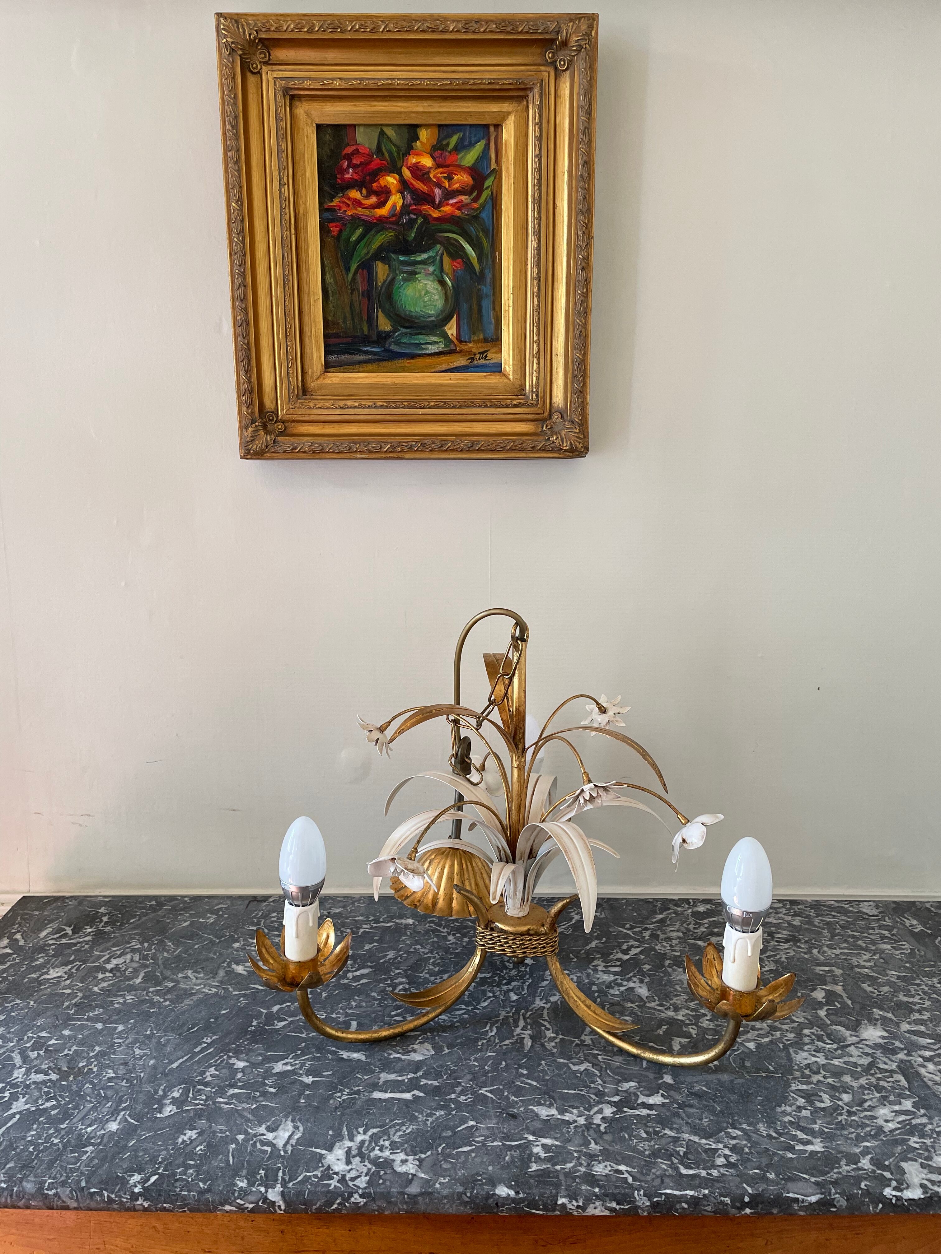 Golden metal chandelier decorated with flowers
