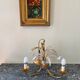 Golden metal chandelier decorated with flowers