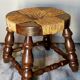 Low vintage regional stool in solid wood with straw top