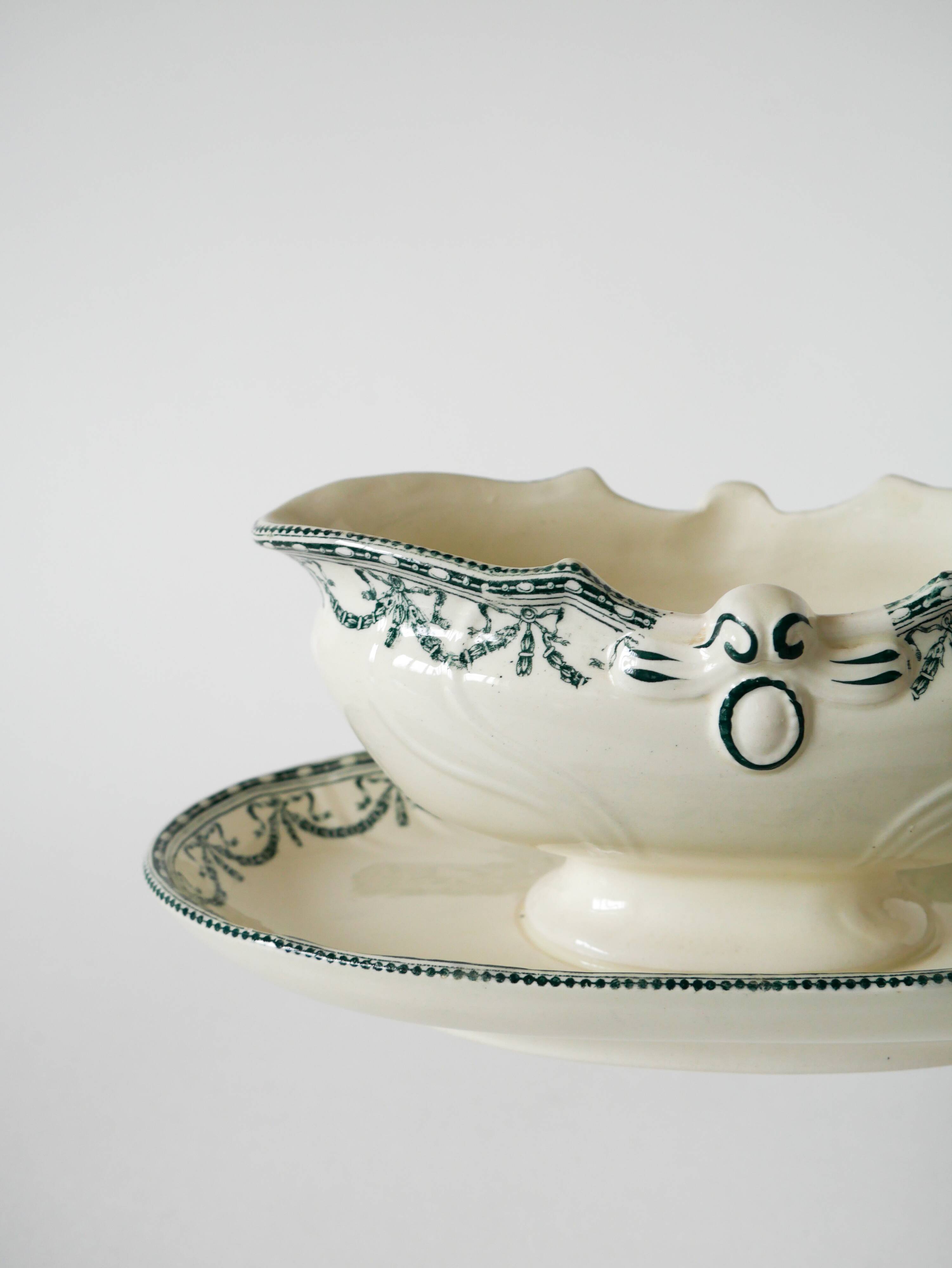 Sauce boat in Salins Iron Earth, "Guirlandes" model, textured version, early 20th century