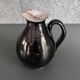 Antique black pitcher with white collar