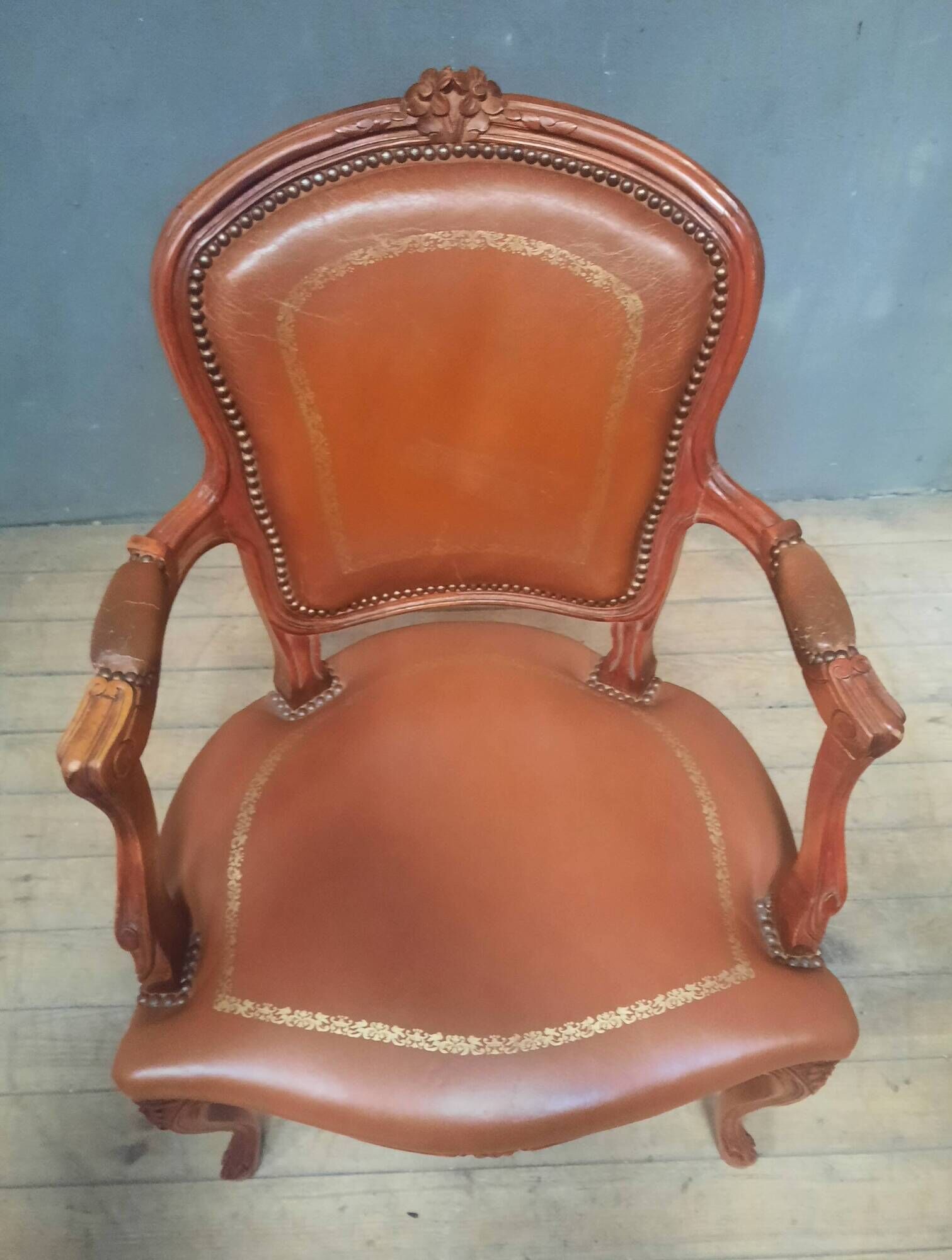 Louis XV style armchair covered in leather.