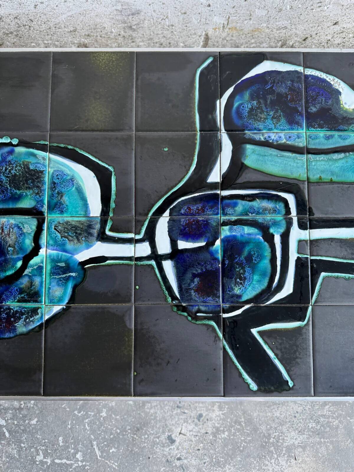 Mid-century Denisco ceramic coffee table — black, blue and white glazed tile top with silver metal base