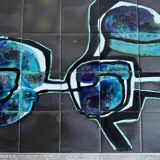 Mid-century Denisco ceramic coffee table — black, blue and white glazed tile top with silver metal base