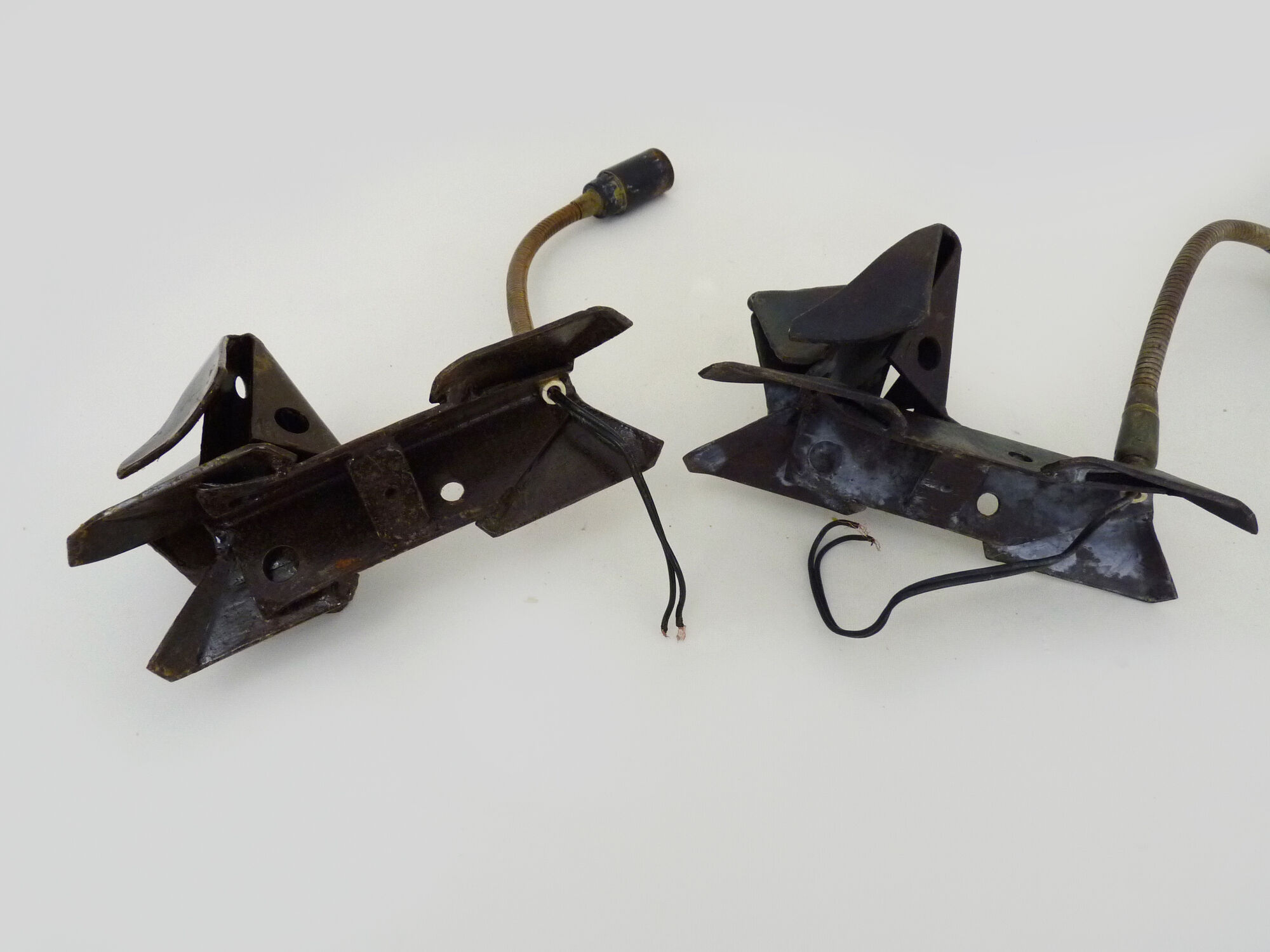 Pair of cast iron wall sconces with articulated arm, dog shape. Vintage