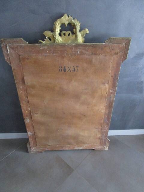 Large antique mirror in wood and gilded stucco.