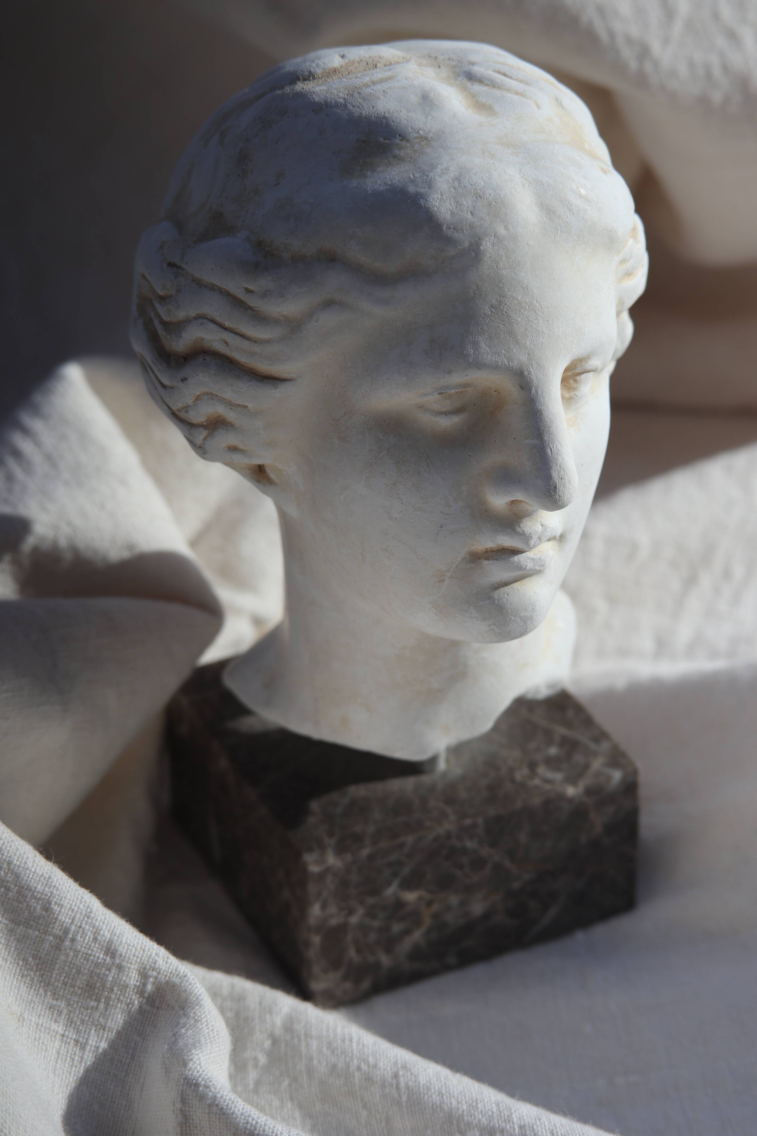 Plaster bust on a pedestal