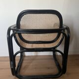 Black armchair with cane and natural rattan