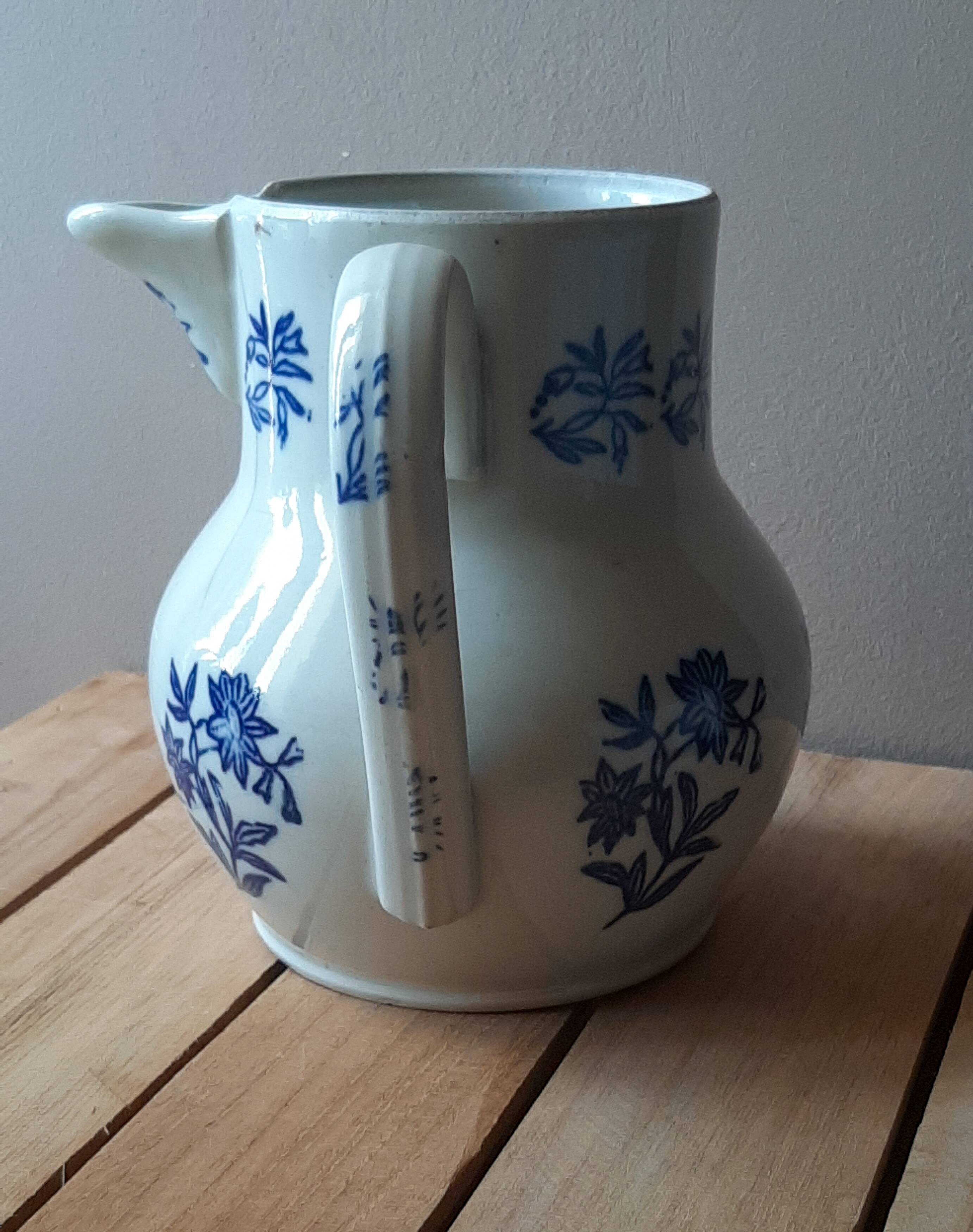 Large antique cruet in Saint Uze earthenware with blue flowers.