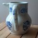 Large antique cruet in Saint Uze earthenware with blue flowers.