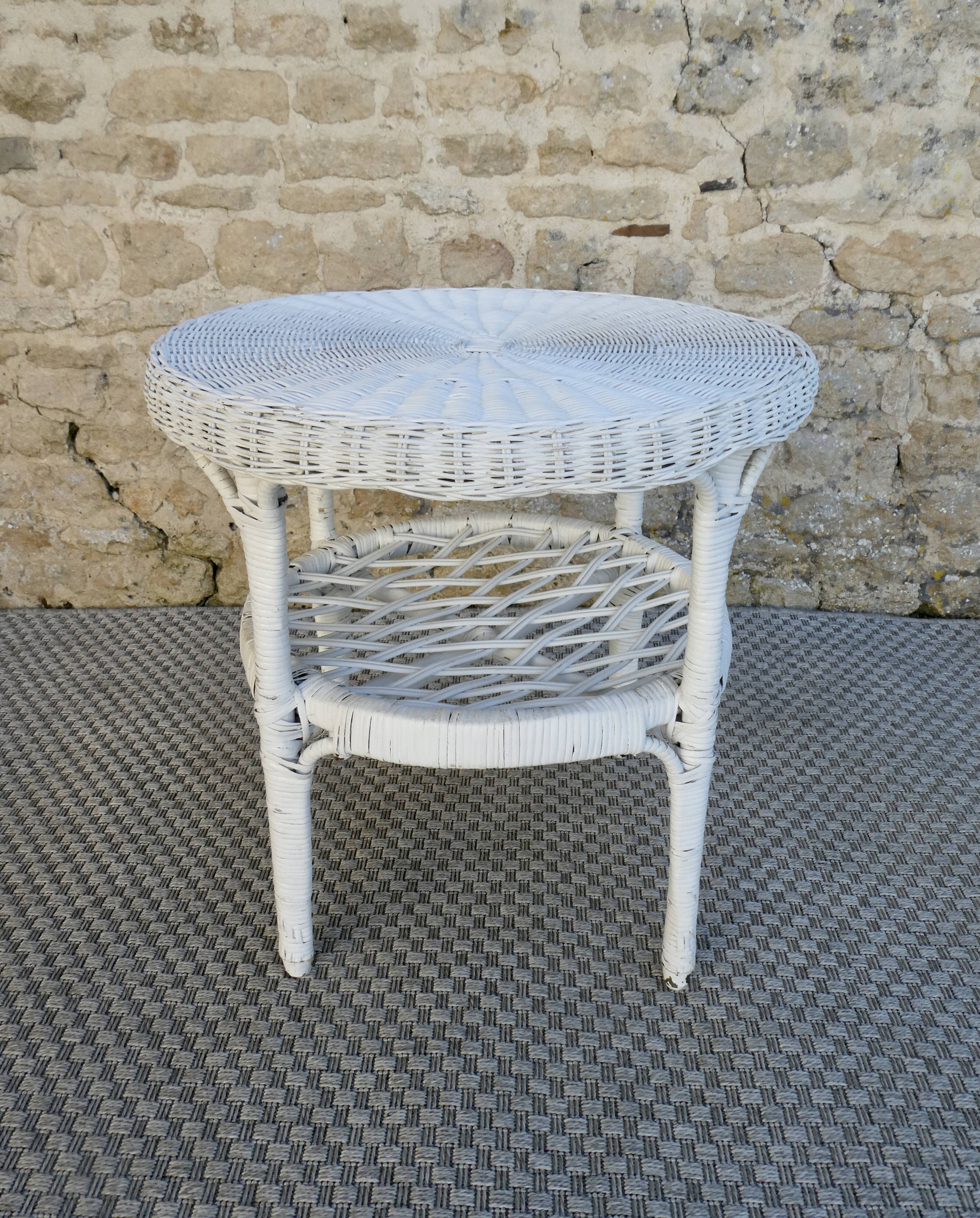 Round white rattan side table with storage underneath, circa 1970.