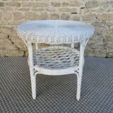 Round white rattan side table with storage underneath, circa 1970.