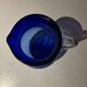 Vintage cobalt blue blown glass jug with a transparent handle.
