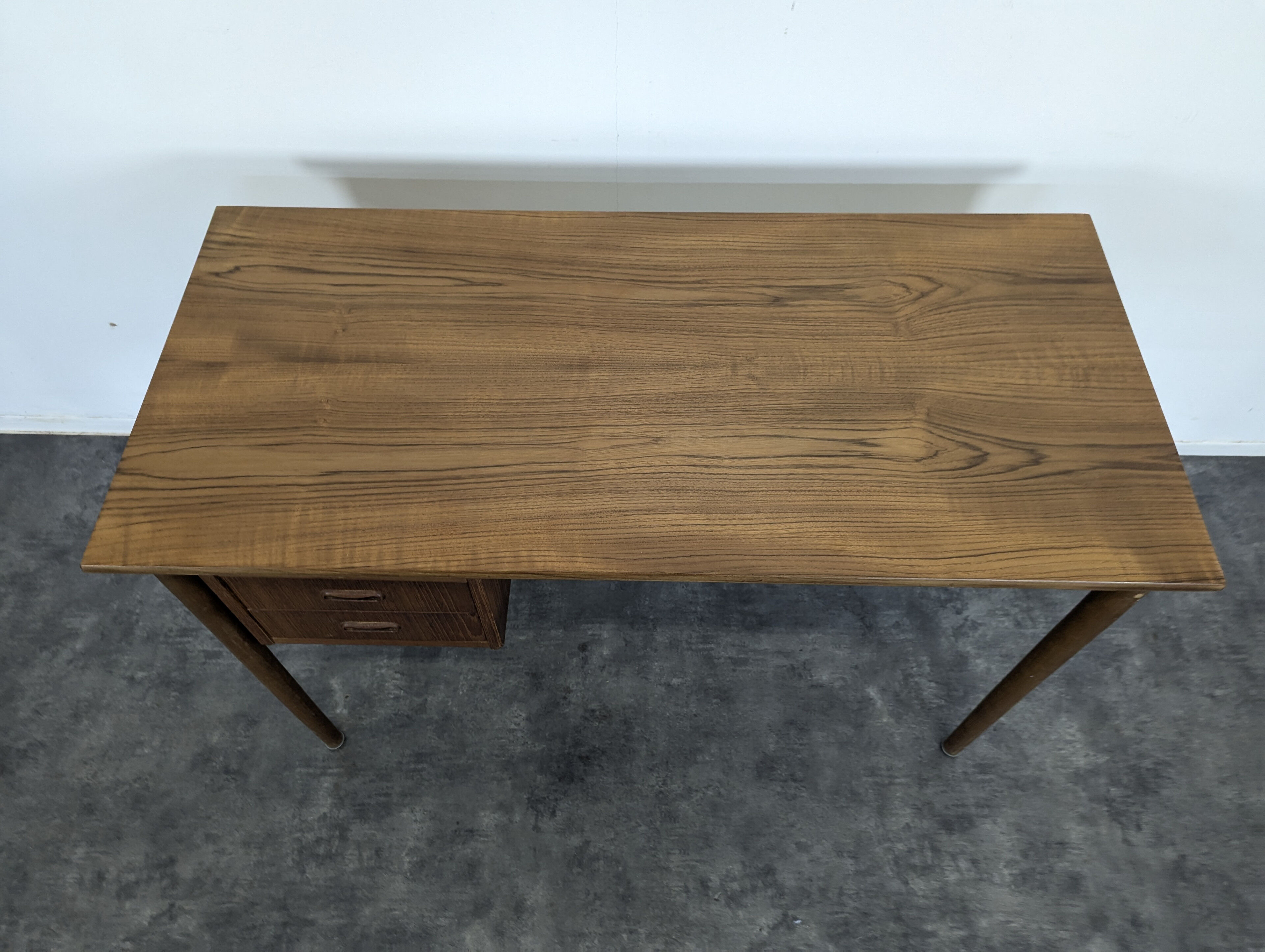 Scandinavian teak desk with a suspended drawer unit.
