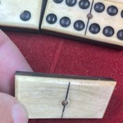 Set of complete dominoes made of bone, nails and blackened wood