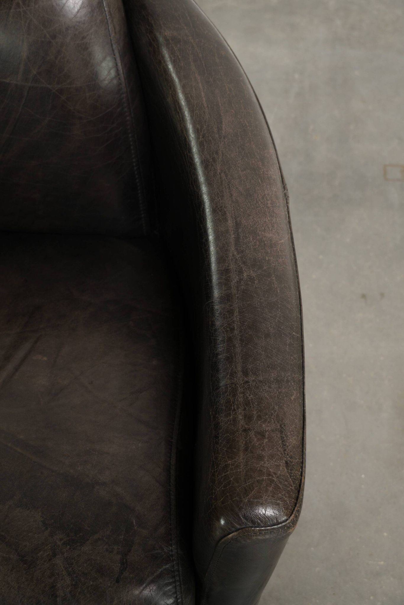 Cow leather Aviator design armchair in a dark colour scheme