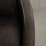 Cow leather Aviator design armchair in a dark colour scheme