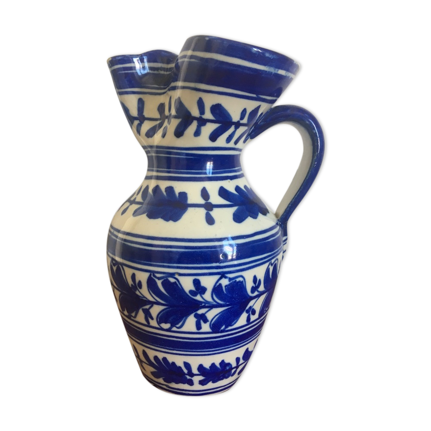 Enamelled ceramic pitcher, blue and white floral decoration, signed