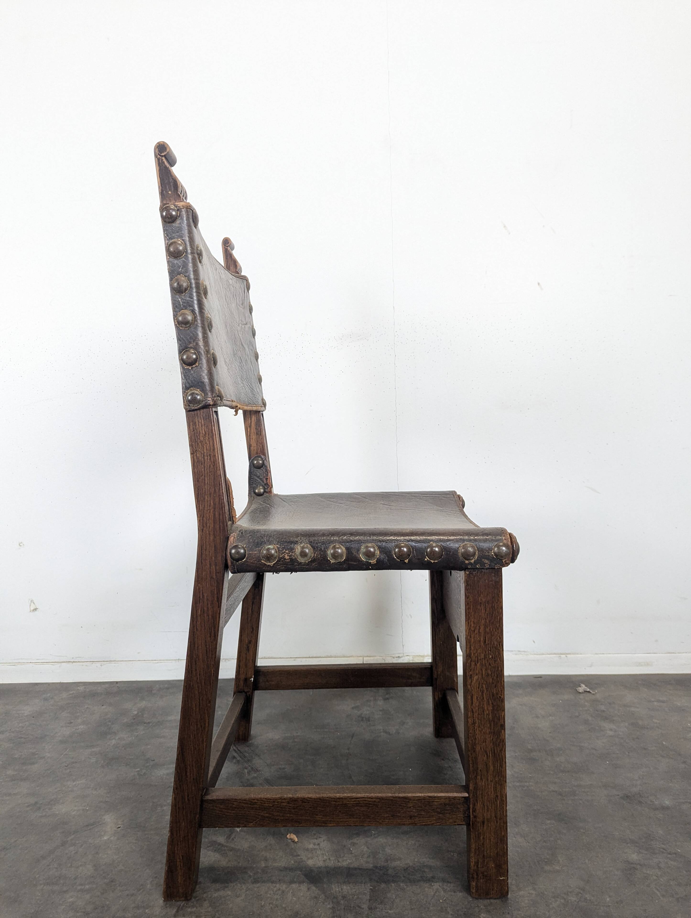 Set of 8 Gothic-style chairs in oak and studded leather.