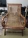 Colonial planter's armchair in solid teak, scroll armrests, caned seat.
