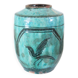 Chinese glazed earthenware vase with bird and flower decoration on a green background