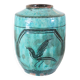Chinese glazed earthenware vase with bird and flower decoration on a green background