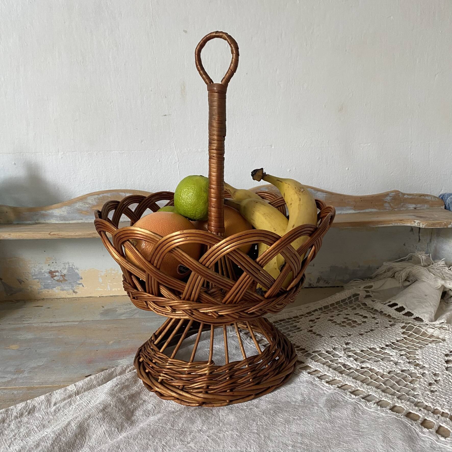 Wicker fruit bowl on a stand