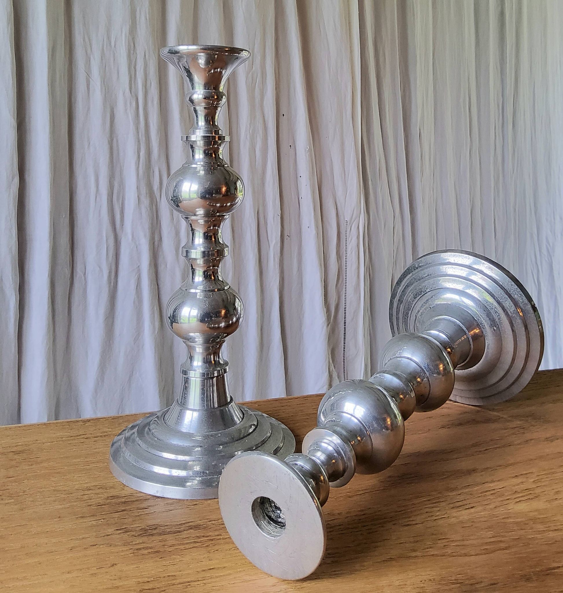 Pair of antique chrome metal candlesticks