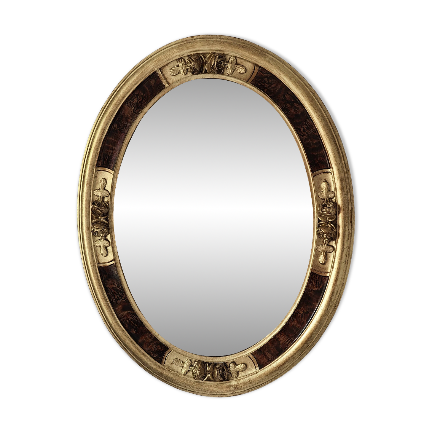 Antique medallion mirror with a gilded and relief-carved frame.
