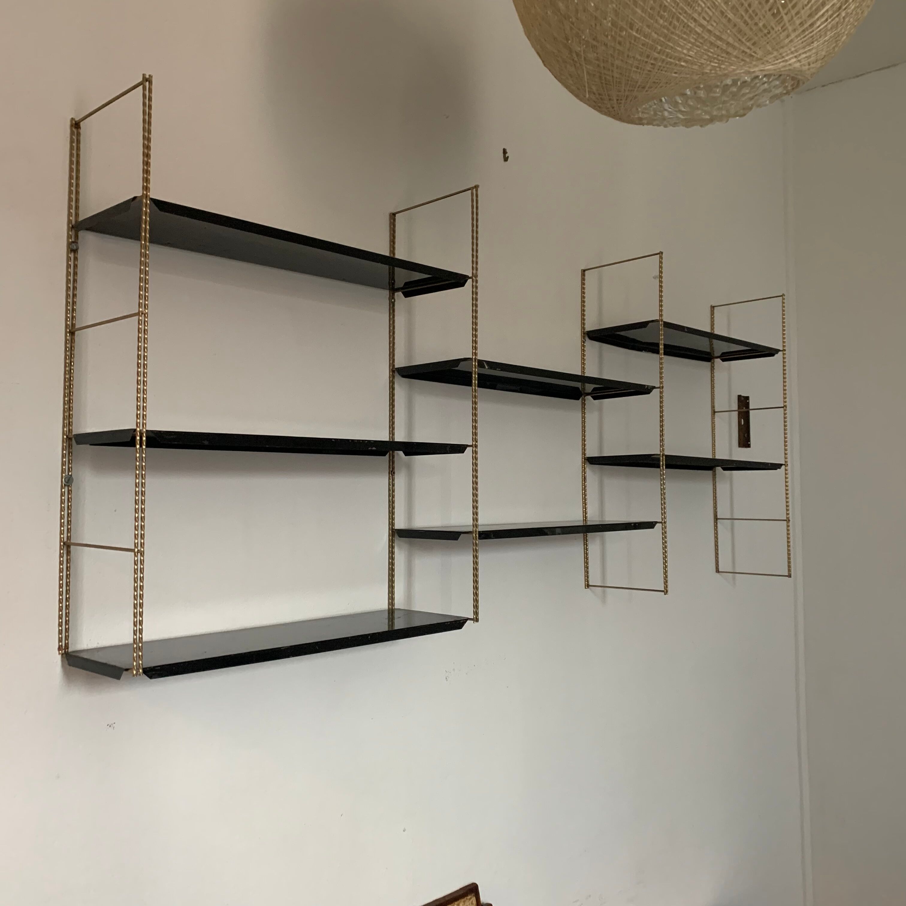 Vintage wall shelves in gold and black metal