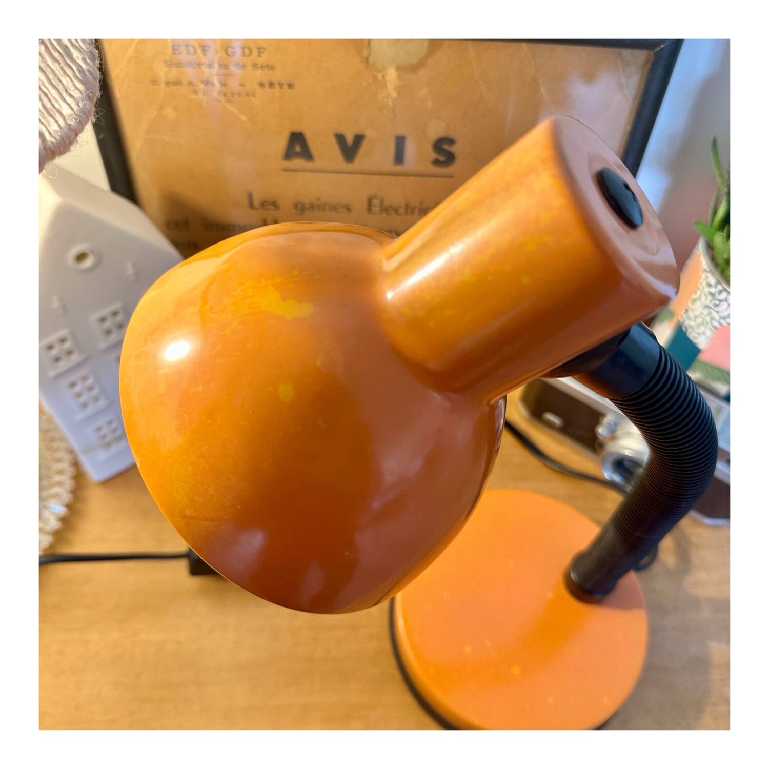 Orange articulated desk lamp