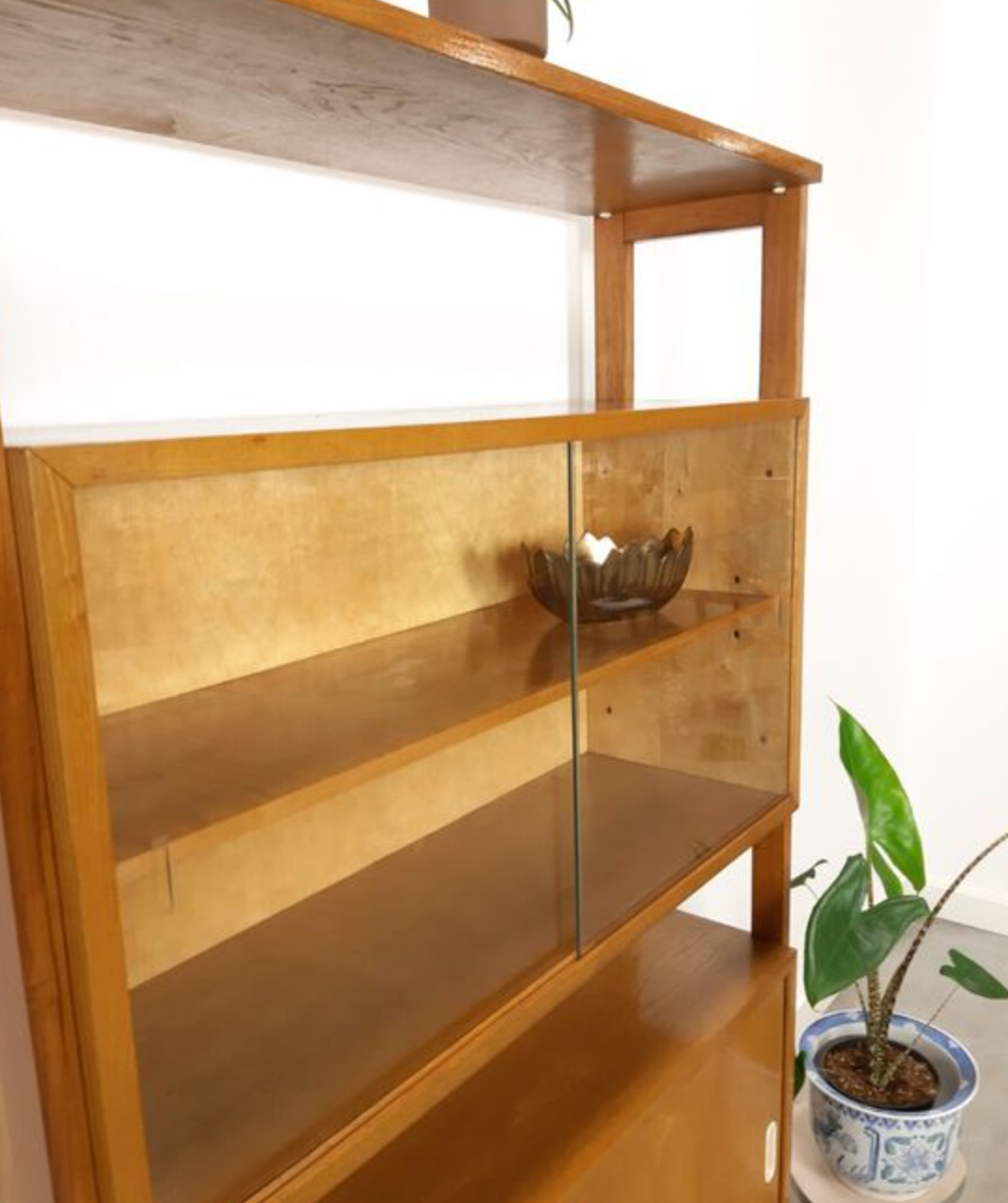 Vintage wooden showcase with sliding doors and white handles