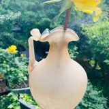 Old decorative carafe in li-colored glass