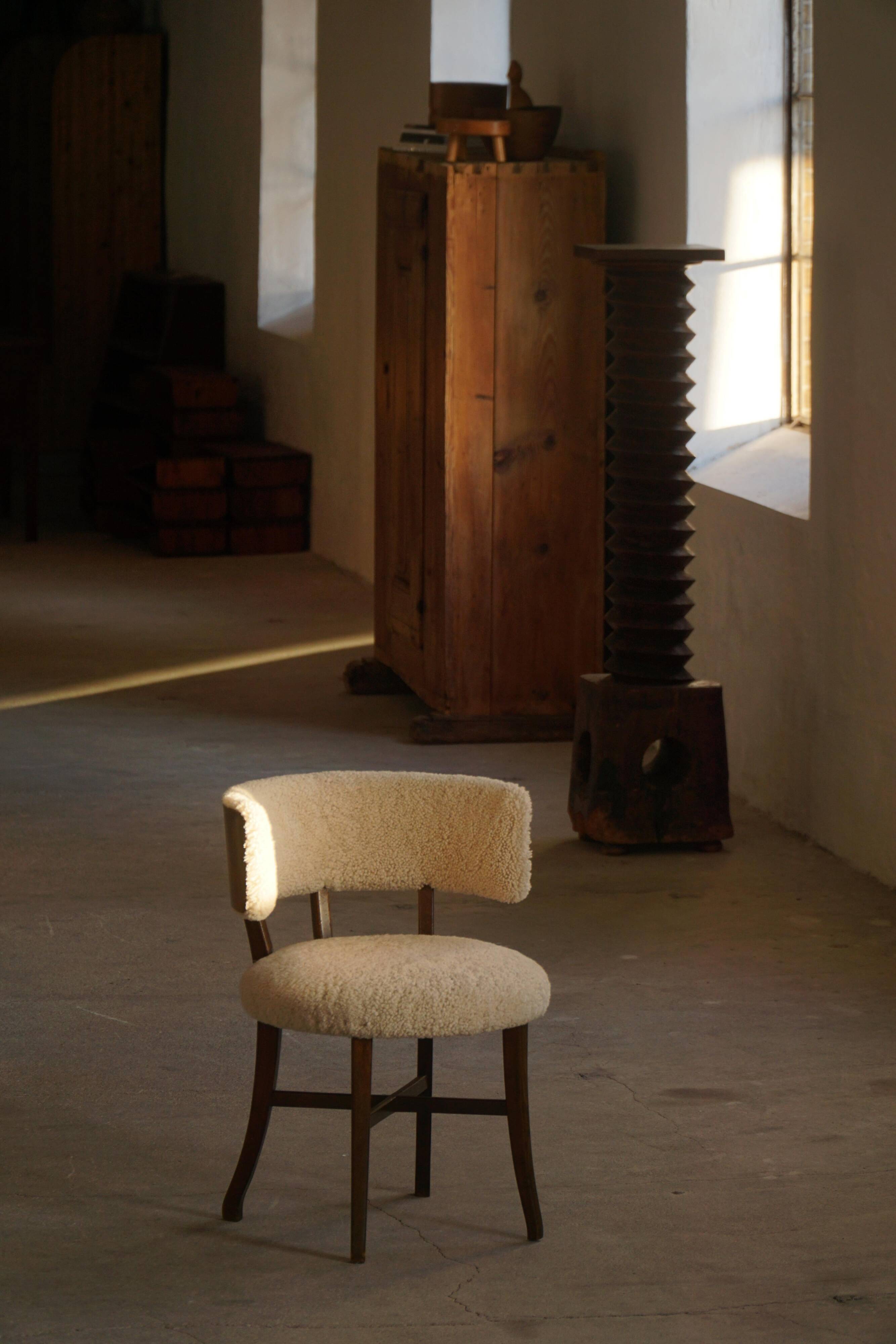 A modern Danish elegant low-back chair, reupholstered in lambswool, 1940s.