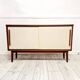 Mid-century teak sideboard with white synthetic doors.