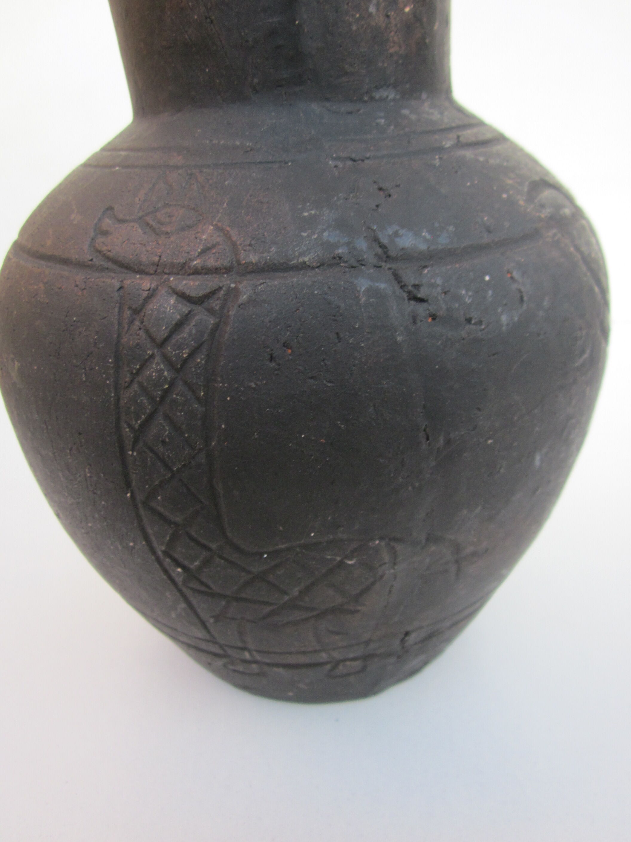 Black African pottery with stylized giraffe pattern