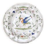 Hollow plate in Moustiers faience decorated with a bird, 19th century.