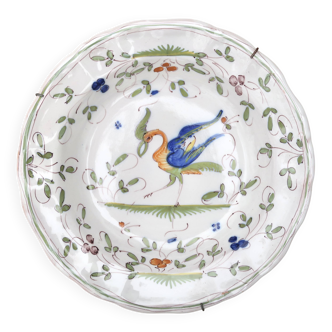 Hollow plate in Moustiers faience decorated with a bird, 19th century.
