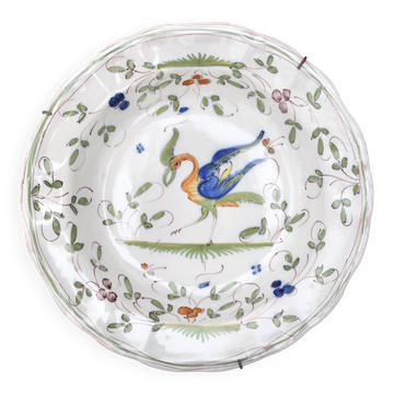 Hollow plate in Moustiers faience decorated with a bird, 19th century.
