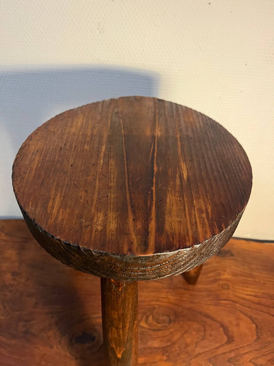 Round wooden tripod stool