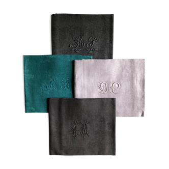 Set of four old damasked and monogrammed towels, tinted multiple colors