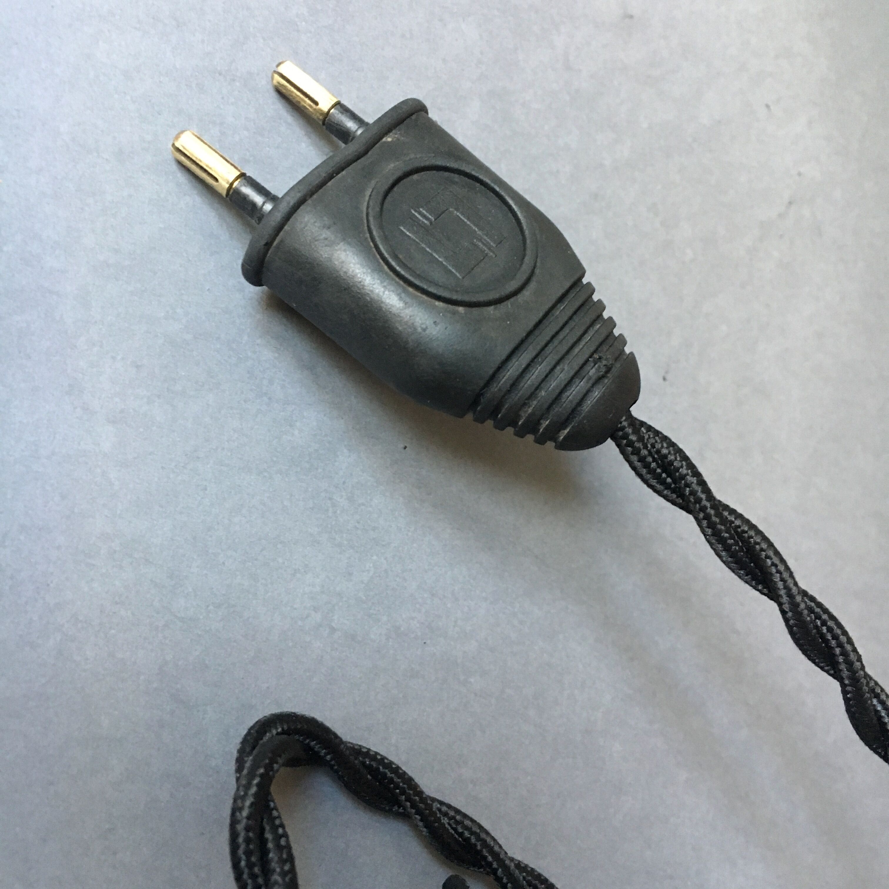 Old industrial lamp has vise 'mazda '.