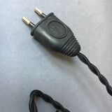 Old industrial lamp has vise 'mazda '.