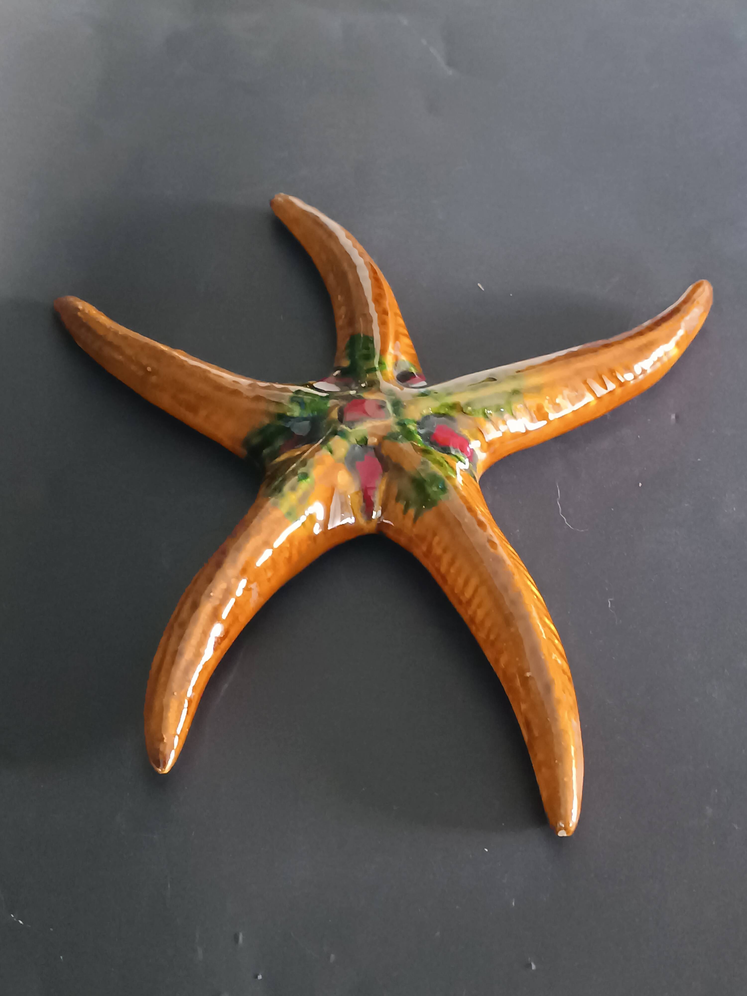 Two vintage ceramic wall pots featuring a seahorse and a starfish.