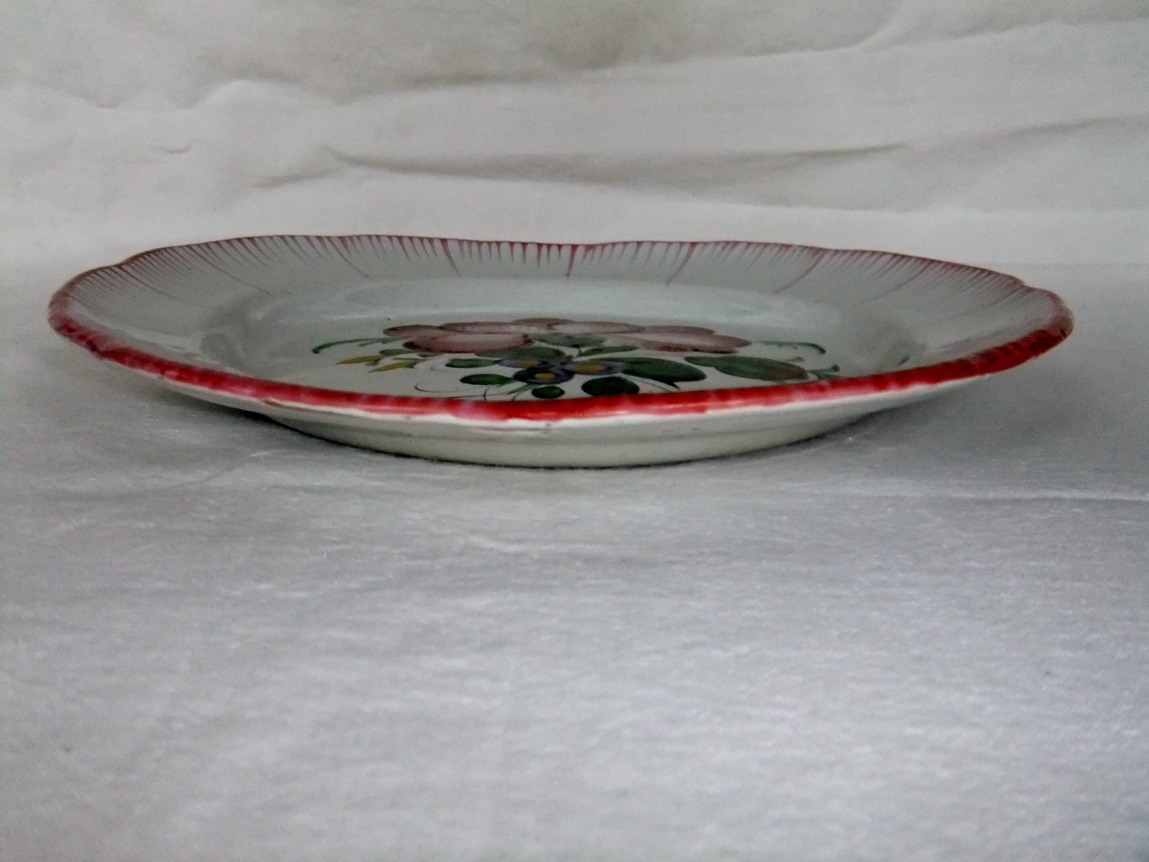 Old earthenware plate of the East Strasbourg decorated with flowers