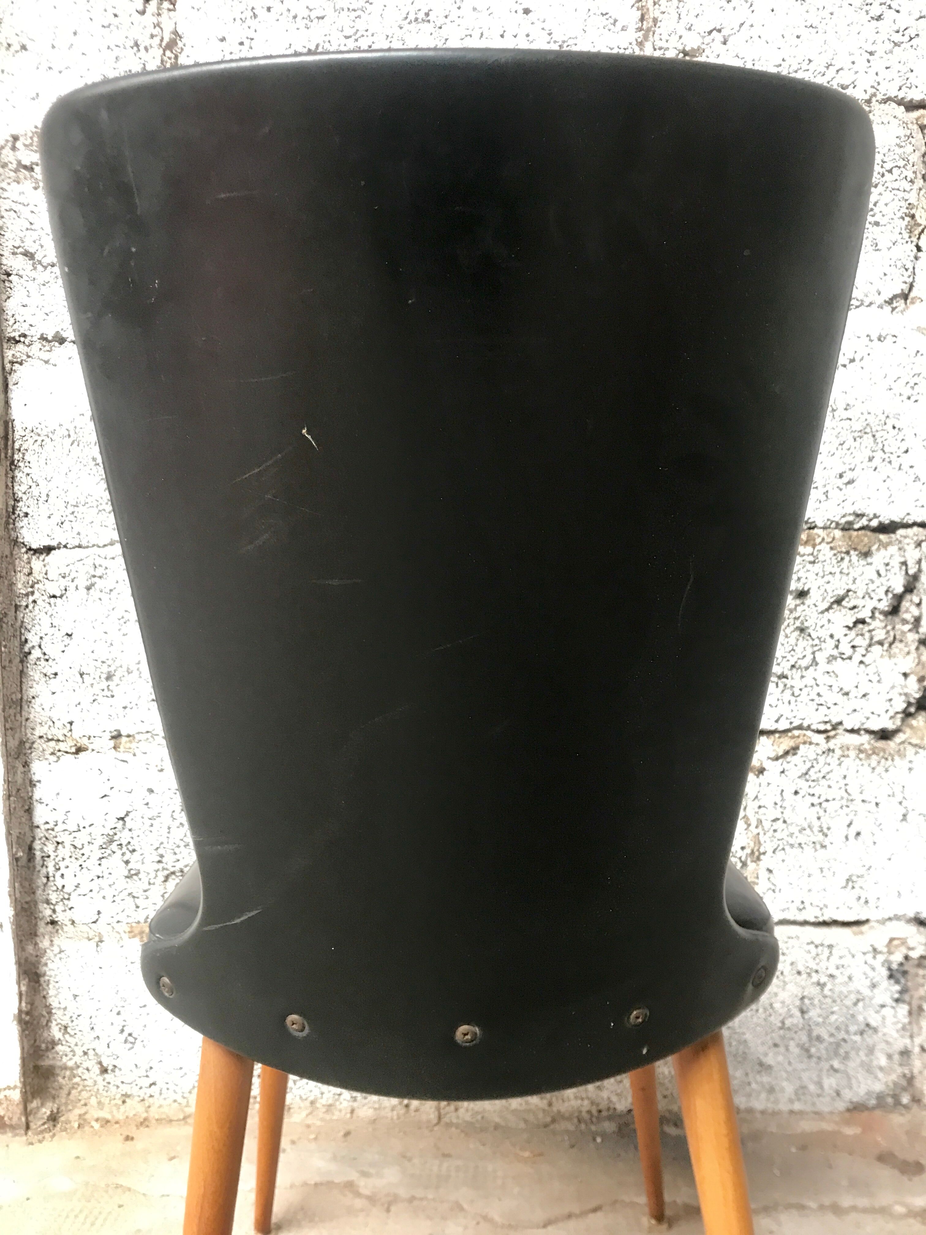 Pair of Baumann model Essor chairs in faux black leather, beech compass footing