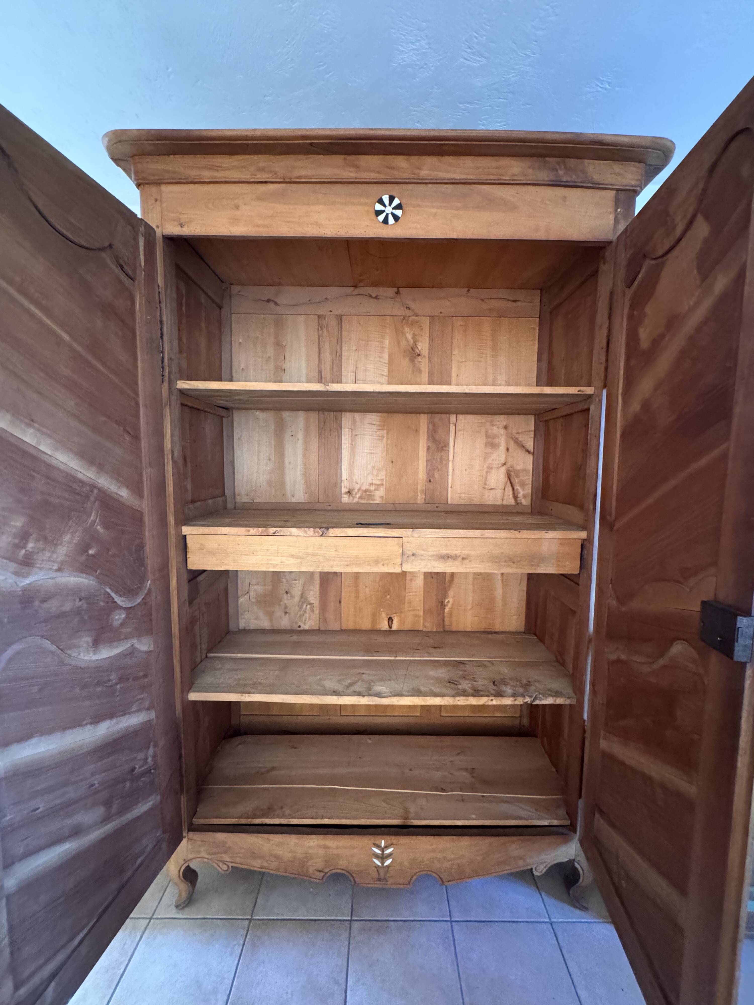 Antique 2-door wardrobe made of solid wood with shelves and drawers.